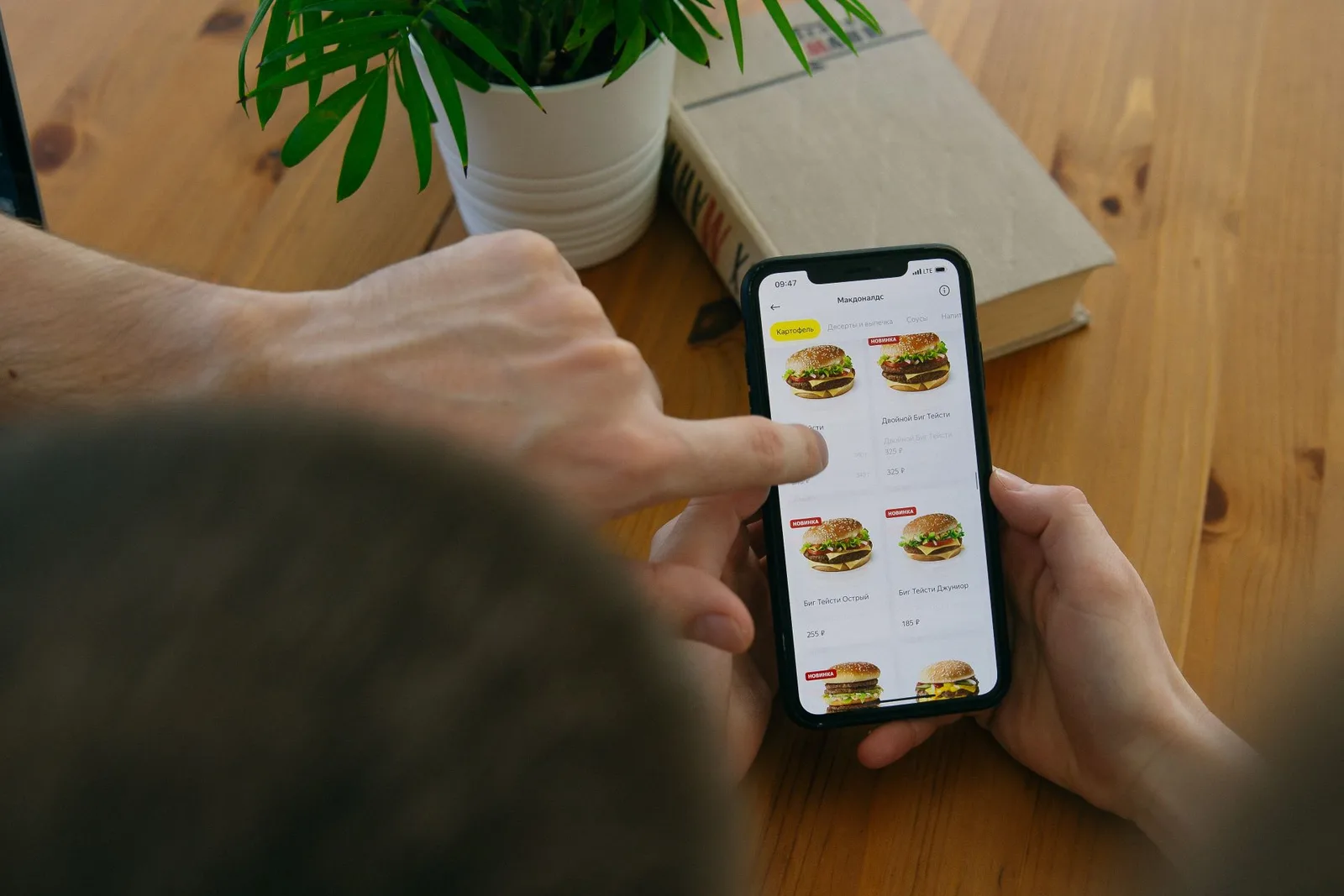 Guests at a restaurant table looking at the digital menu on their phones